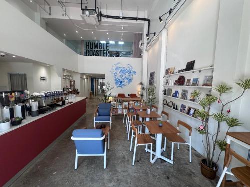 a restaurant with tables and chairs and a counter at Bubble Humble Bangkok By Canal in Bangkok