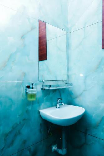 a bathroom with a sink and a mirror at The Gripa Hotels in Chitrakoot