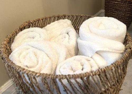 a basket filled with white towels in a room at Hidden Gem Steps From River, Restos, Cafés, Parks in Windsor