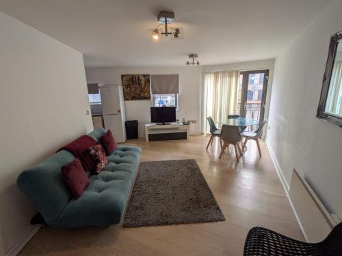 a living room with a couch and a table at 2 Bedroom 2 Bath Apartment, sleeps 4, Town Centre in Wolverhampton