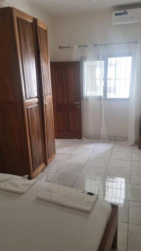 a room with two beds and wooden cabinets at Résidence PAYAN in Douala