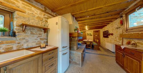 a kitchen with a white refrigerator and a sink at Къща за гости "Панорама" Проглед in Smolyan