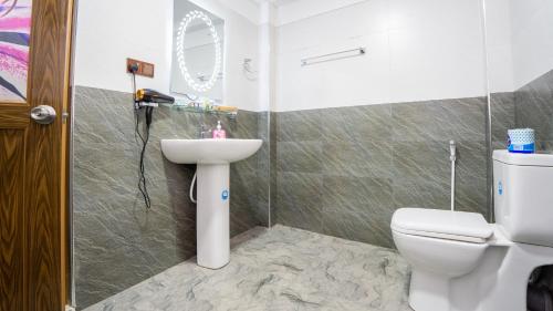a bathroom with a toilet and a sink at Tranquil Guest in Sigiriya