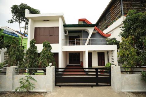 a house with a gate in front of it at Ashiyana Homes in Nedumbassery
