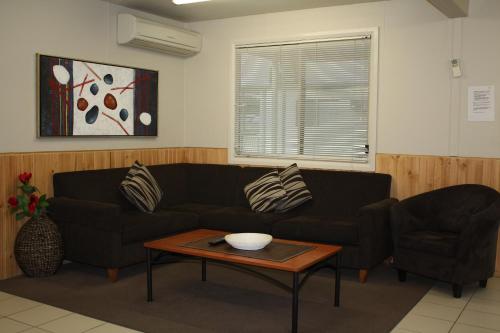 a living room with a couch and a table at Ingenia Holidays Nepean River in Emu Plains