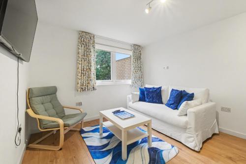 a living room with a white couch and a chair at Central London flat 10 min to Westminster in London