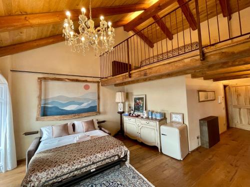 a bedroom with a bed and a chandelier at La Blu di Via Silvano 8 in Monforte dʼAlba