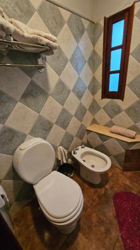 a bathroom with a toilet and a bidet at Casona El Rosedal in Bell Ville
