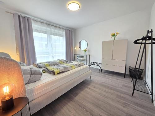 a bedroom with a bed and a large window at Ferienwohnung NorderHafen in Norden