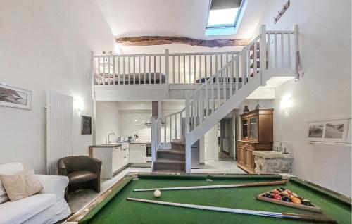 a living room with a pool table and stairs at Luxueuse Maison Avec Piscine in Cravans