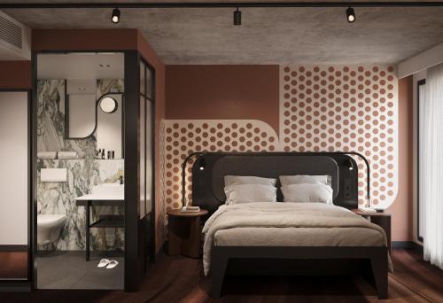a bedroom with a bed and a bathroom with a sink at TRIBE PARIS SURESNES in Suresnes