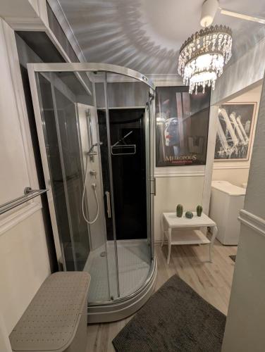 a bathroom with a shower with a chandelier at Villa Clara in Blankaholm