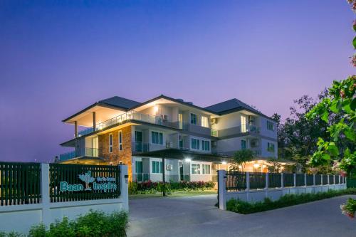 una casa grande con una valla delante en Baan I Inspire, en Phrae