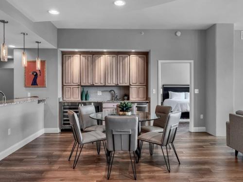a kitchen and dining room with a table and chairs at Luxurious Penthouse with large patio in Orlando