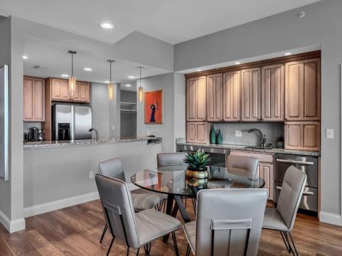 a kitchen and dining room with a table and chairs at Luxurious Penthouse with large patio in Orlando