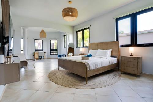 a bedroom with a large bed and a living room at Spacious House with Pool and BBQ in Arenales