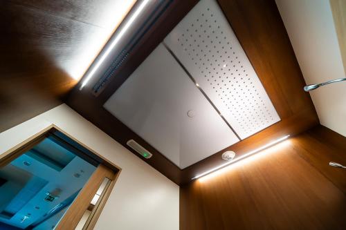 a room with a large window and a wooden door at Sleepover Terminal 3, Concourse A - formerly sleep 'n fly in Dubai