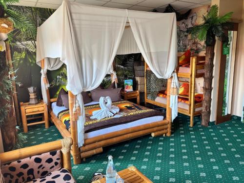 a bedroom with two bunk beds and a canopy at Hotel Berlin in Leipzig