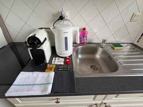 a kitchen counter with a sink and a mixer at Studio au château in Monchy-Humières