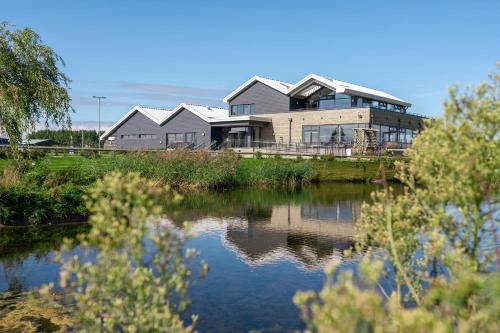 a building next to a body of water at Unity Beach in Berrow