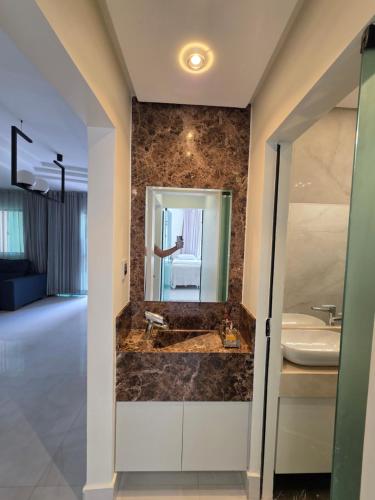 a bathroom with a sink and a mirror at Inocoop house in Camaçari