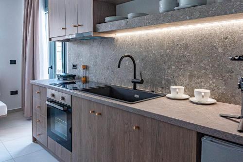 a kitchen with a sink and a counter at Opulence12 Suites in Karpathos
