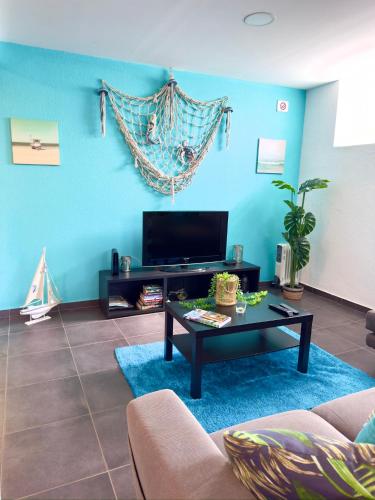 a living room with a couch and a coffee table at O Cantinho do Zé in Funchal