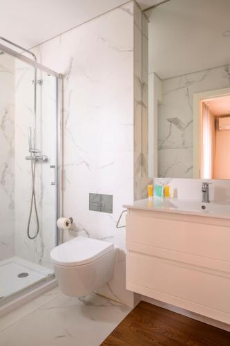 a bathroom with a toilet and a sink and a shower at Terro Collection - Eça de Queirós in Braga