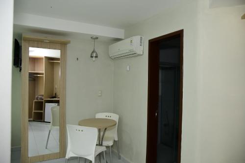 a room with a table and chairs and a kitchen at Hotel Serrano Martins in Martins