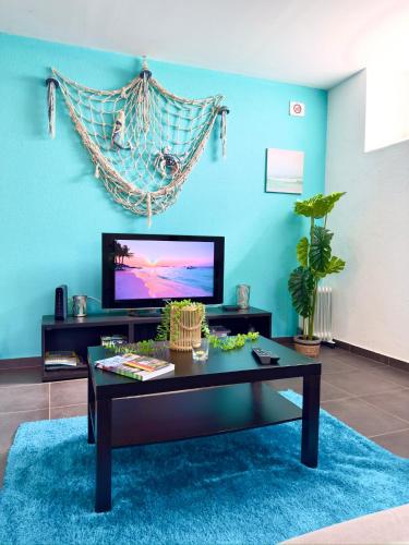 a living room with a coffee table and a tv at O Cantinho do Zé in Funchal