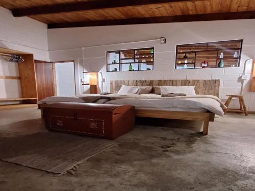 a large bedroom with two beds and a suitcase at Wild Eden Self-Catering Accommodation in Swakopmund