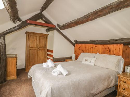a bedroom with a bed with towels on it at Cottage 1 in Keswick