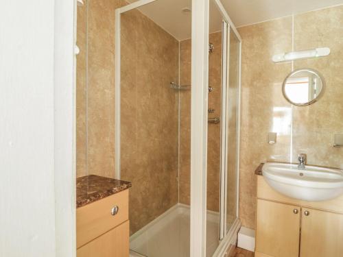 a bathroom with a sink and a shower at Cottage 1 in Keswick