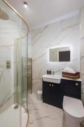 a bathroom with a shower and a toilet and a sink at 35 Kirkgate in Thirsk