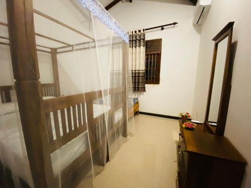 a hallway with a glass wall in a room at VILLA Sea La THALPE in Talpe