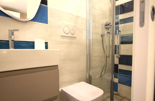 a bathroom with a shower and a toilet and a sink at Appartamento Dea in Marina di Campo