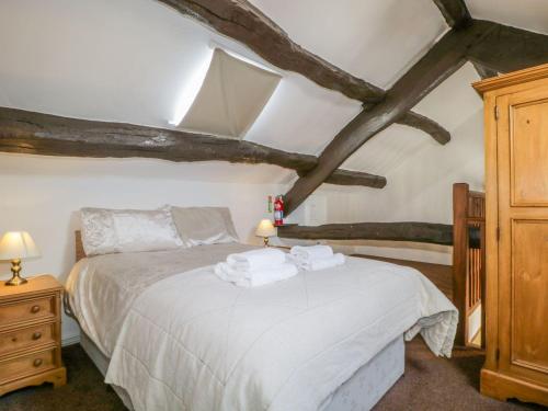 a bedroom with a bed with towels on it at Cottage 2 in Keswick