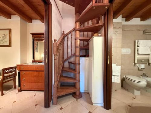a bathroom with a spiral staircase and a refrigerator at DOMA LUXURY HOMe in Desenzano del Garda