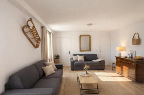 a living room with a couch and a table at Mountain getaway in Saint-Chaffrey in Saint-Chaffrey