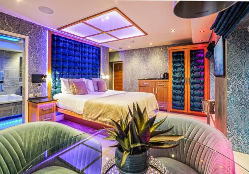 a bedroom with a bed and a couch at Church Suites by The Cranleigh Boutique in Bowness-on-Windermere