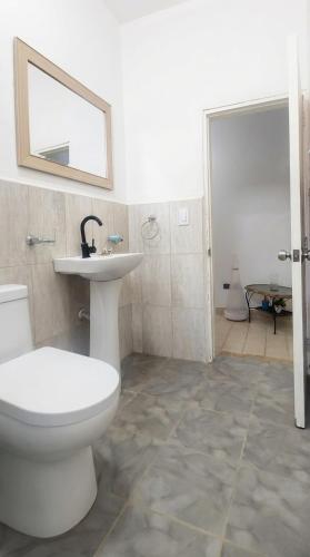 a bathroom with a toilet and a sink at Apto cerca a Paseo Colon in Puerto La Cruz