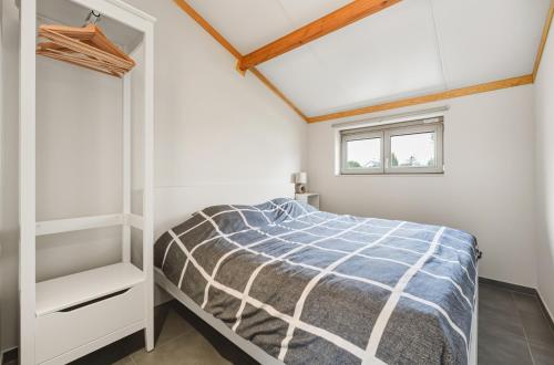 a bedroom with a bed and a window at Duinhuis 20 P in Oostduinkerke