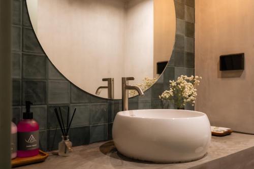 a bathroom with a sink and a mirror at Aloha Tropicana Samui in Chaweng