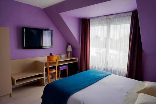 a purple bedroom with a bed and a desk with a television at Hotel Ker Vennaik in Bénodet