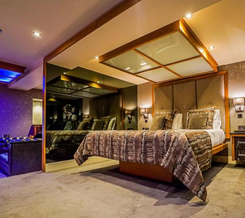 a bedroom with two beds and a large mirror at Church Suites by The Cranleigh Boutique in Bowness-on-Windermere