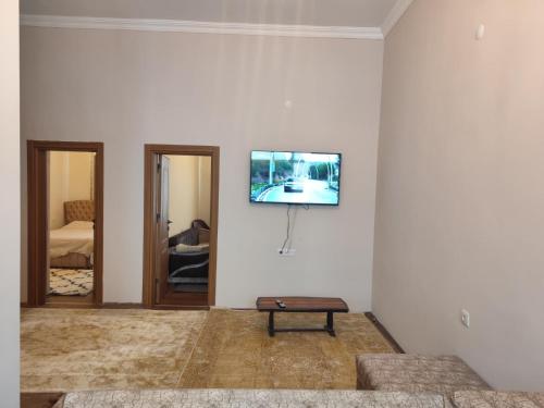 a living room with a tv on a white wall at Yörük konaklama in Burdur