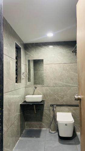a bathroom with a sink and a toilet at Hotel Leaf inn in Ahmedabad