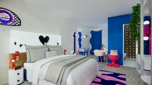 a bedroom with a large bed and blue and white walls at Symone - Poitiers in Poitiers