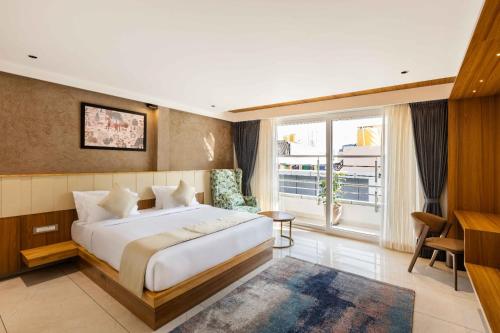 a hotel room with a bed and a large window at AIRA Boutique Hotel in Bangalore