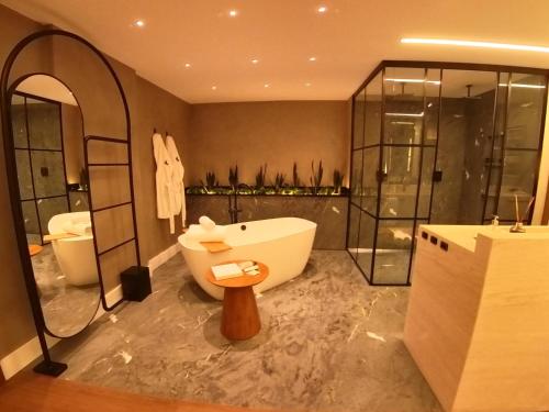 a large bathroom with a tub and a sink at Fazzenda Park Resort in Gaspar
